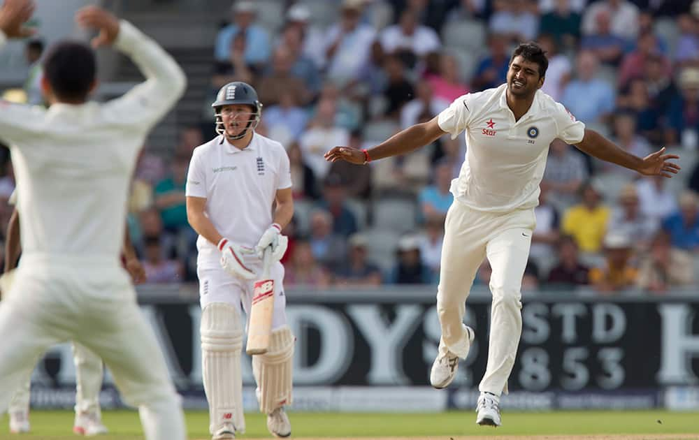 Pankaj Singh, right, reacts after a shot by England's Ian Bell at Old Trafford cricket ground on the first day of the fourth test match of their five match series, in Manchester, England.