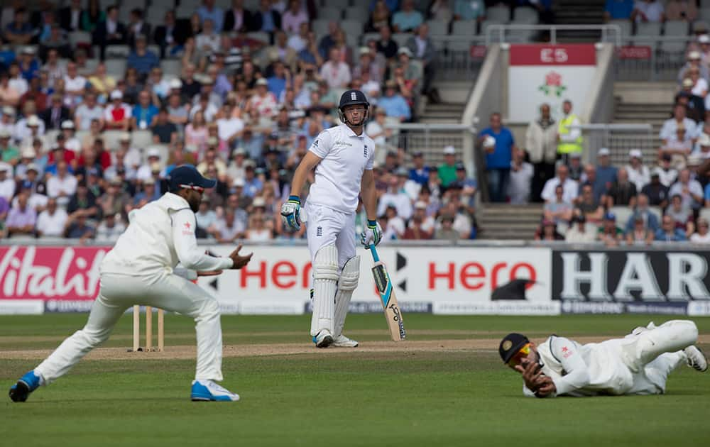 England's Jos Buttler survives a catching attempt by India's Virat Kohli on the third day of the fourth test match of their five match series at Old Trafford cricket ground, in Manchester, England.