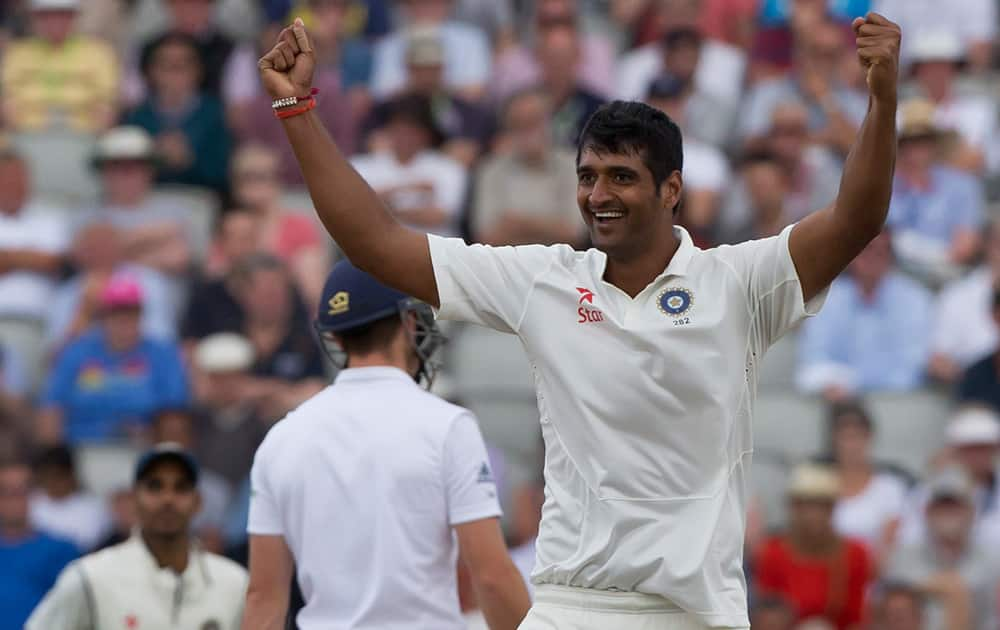 India's Pankaj Singh celebrates after taking the wicket of England's Jos Buttler, caught by Cheteshwar Pujara for 70, on the third day of the fourth test match of their five match series at Old Trafford cricket ground, in Manchester, England.