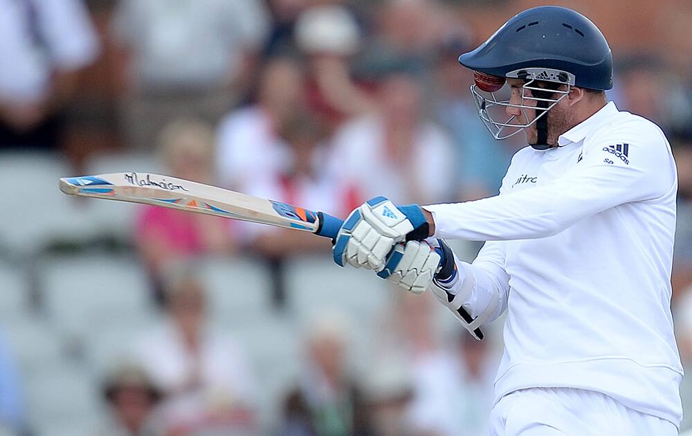 England's Stuart Broad with the ball struck in his visor spins away after being struck in the face by India's Varun Aaron on the third day of the fourth test match of their five match series at Old Trafford cricket ground, in Manchester, England.