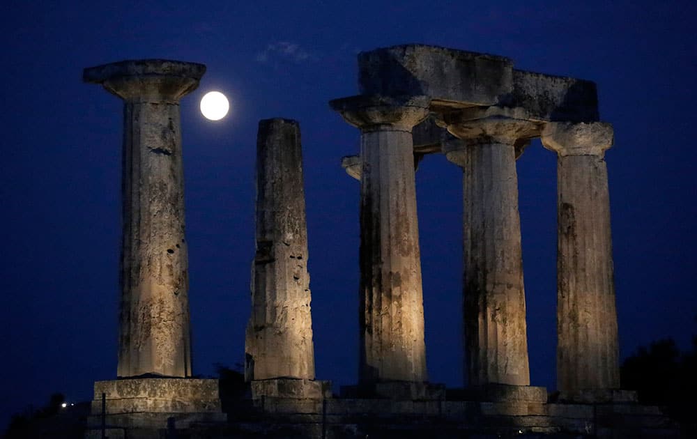 The supermoon rises in the sky in front of the Apollo`s temple at ancient Corinth, about 80 kilometers (50 miles) southwest of Athens.