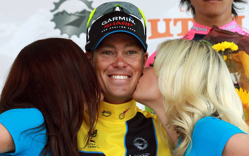 Overall winner Thomas Danielson, of Team Garmin-Sharp, receives a kiss as he celebrates on the podium following the Tour of Utah cycling race.