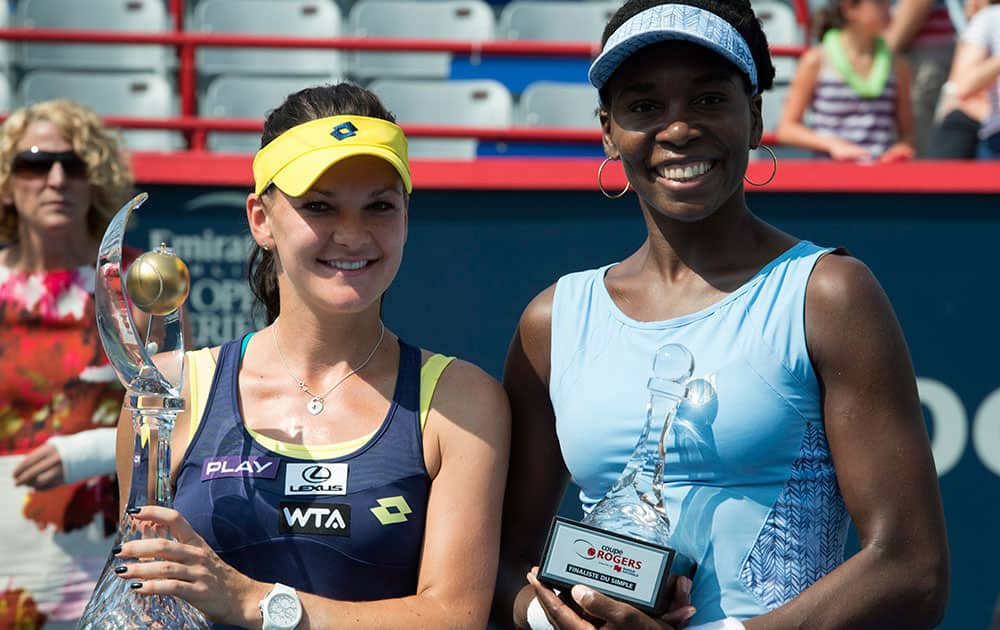 Agnieszka Radwanska, left, of Poland poses with Venus Williams of the United States after winning the final at the Rogers Cup tennis tournament.