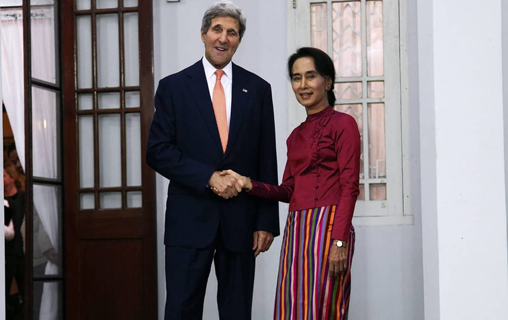 Myanmar opposition leader Aung San Suu Kyi shakes hands with US Secretary of State John Kerry during a photo session before their meeting at her residence in Yangon, Myanmar. 