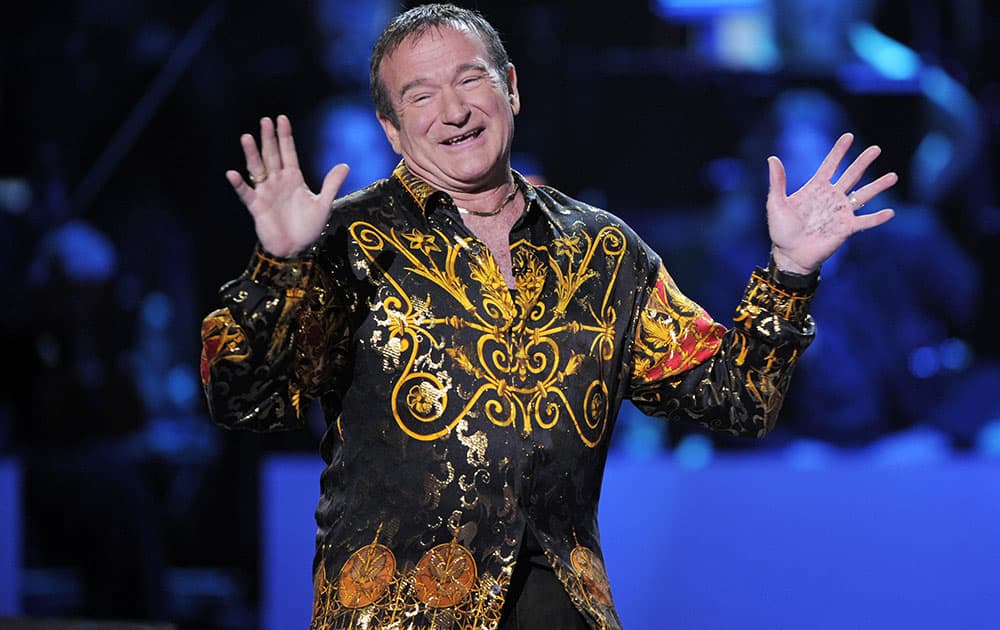 FILE - This April 6, 2008 file photo shows actor-comedian Robin Williams speaks on stage at the 'Idol Gives Back' fundraising special of `American Idol` in Los Angeles. Williams, whose free-form comedy and adept impressions dazzled audiences for decades, has died in an apparent suicide.