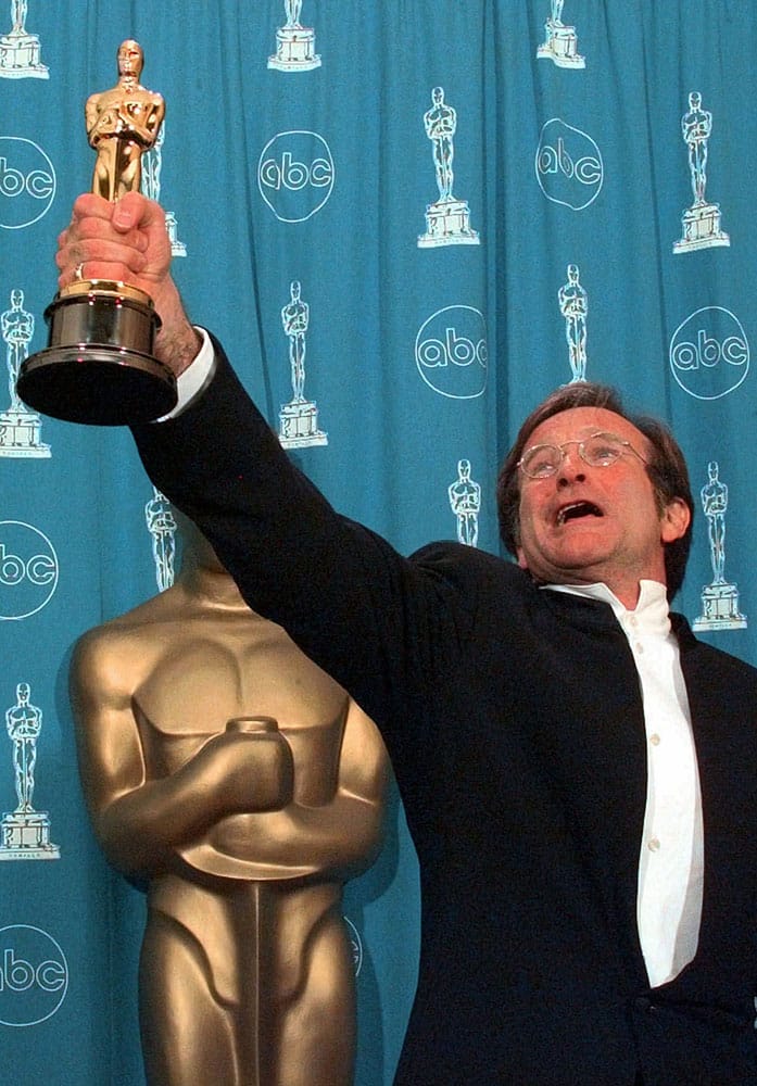 FILE - This March 23, 1998 file photo shows Robin Williams holding his Oscar high backstage at the 70th Academy Awards at the Shrine Auditorium in Los Angeles after won Best Supporting Actor for `Good Will Hunting.`