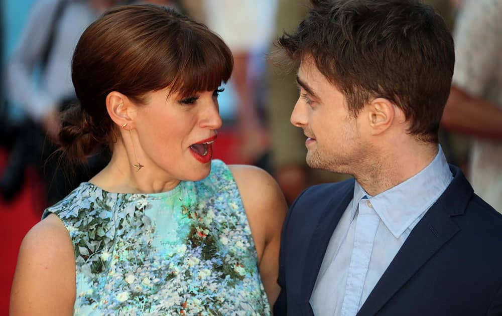 British actors Daniel Radcliffe and Jemima Rooper, react, as they arrive on the red carpet for the UK premiere of What If, at the Odeon West End in central London.