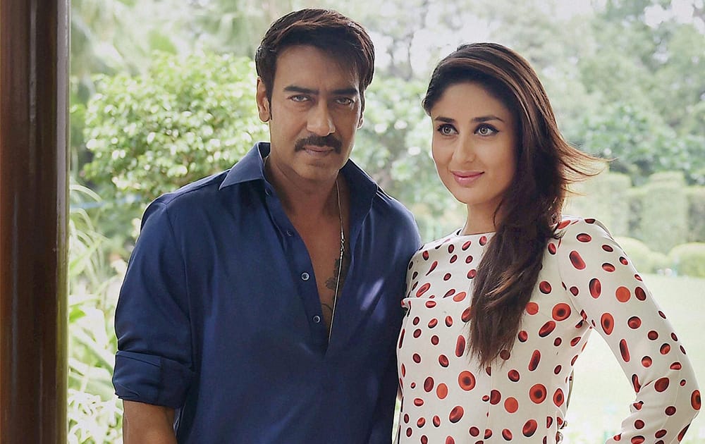 Bollywood actors Kareena Kapoor and Ajay Devgn posing during a promotional event of their film 'Singham Returns'.