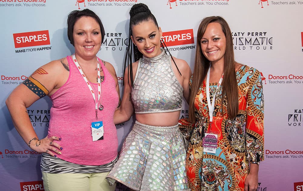 Global pop star Katy Perry, center, with local teachers, left to right, Amanda Workman and Kristie Hofelich backstage at the KFC Yum! Center during her Prismatic World Tour performance in Louisville. 