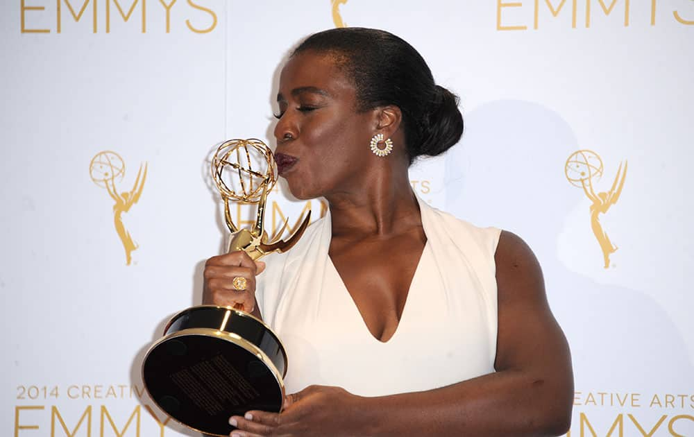 Uzo Aduba poses in the press room with the award for outstanding guest actress in a comedy series for `Orange Is the New Black` at the 2014 Creative Arts Emmys at Nokia Theatre L.A.