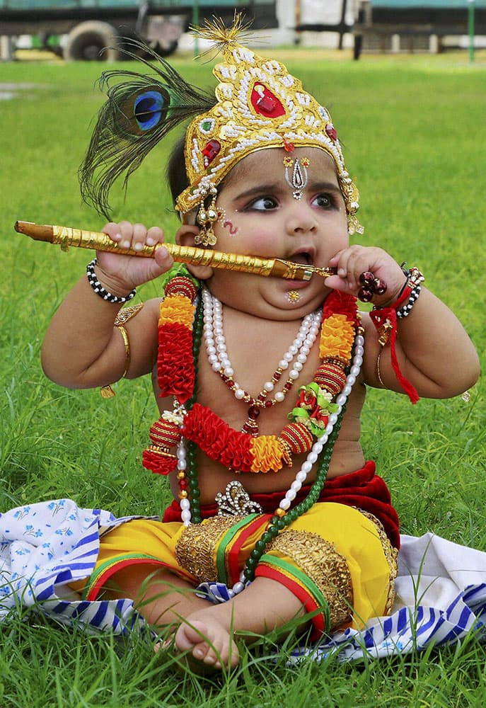 A child dressed up as Lord Krishna participates in 'Bal Gopal' contest on the occasion of Janamashtami festival in Jaipur.