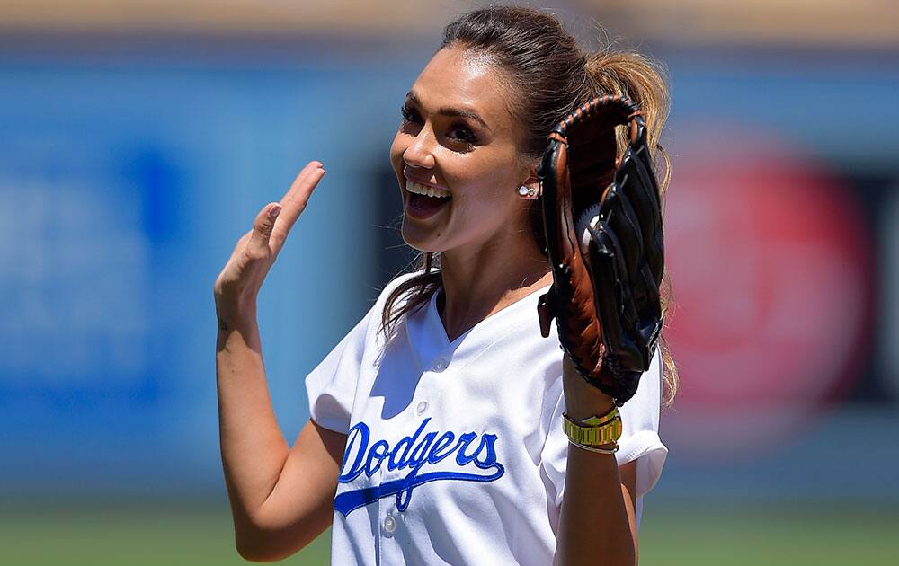 Actress Jessica Alba gestures before throwing out the ceremonial first pitch prior to a baseball game between the Los Angeles Dodgers and the Milwaukee Brewers, in Los Angeles.