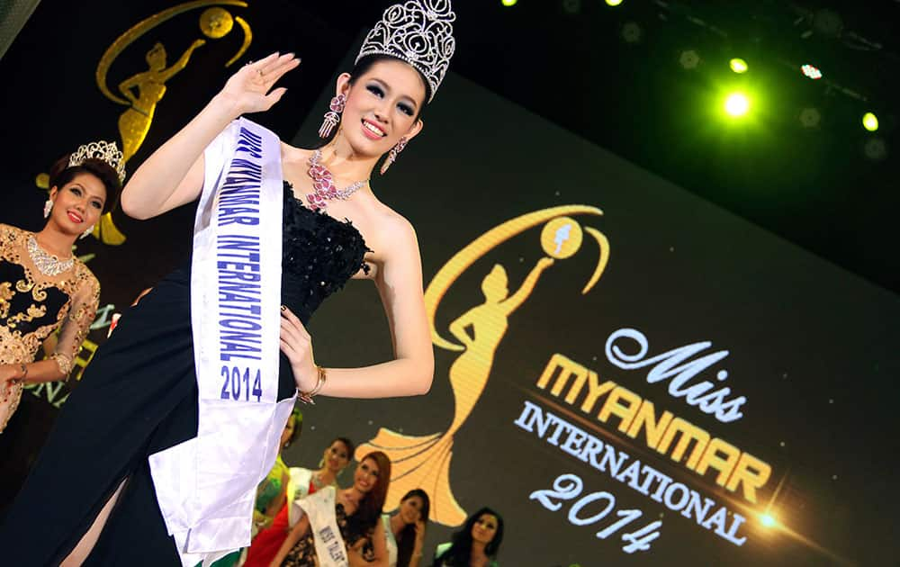 Khin Wai Phyo Han, winner of the Miss Myanmar International pageant, poses for photos after she was crowned at the National Theater Sunday, Aug 17, 2014, in Yangon, Myanmar.