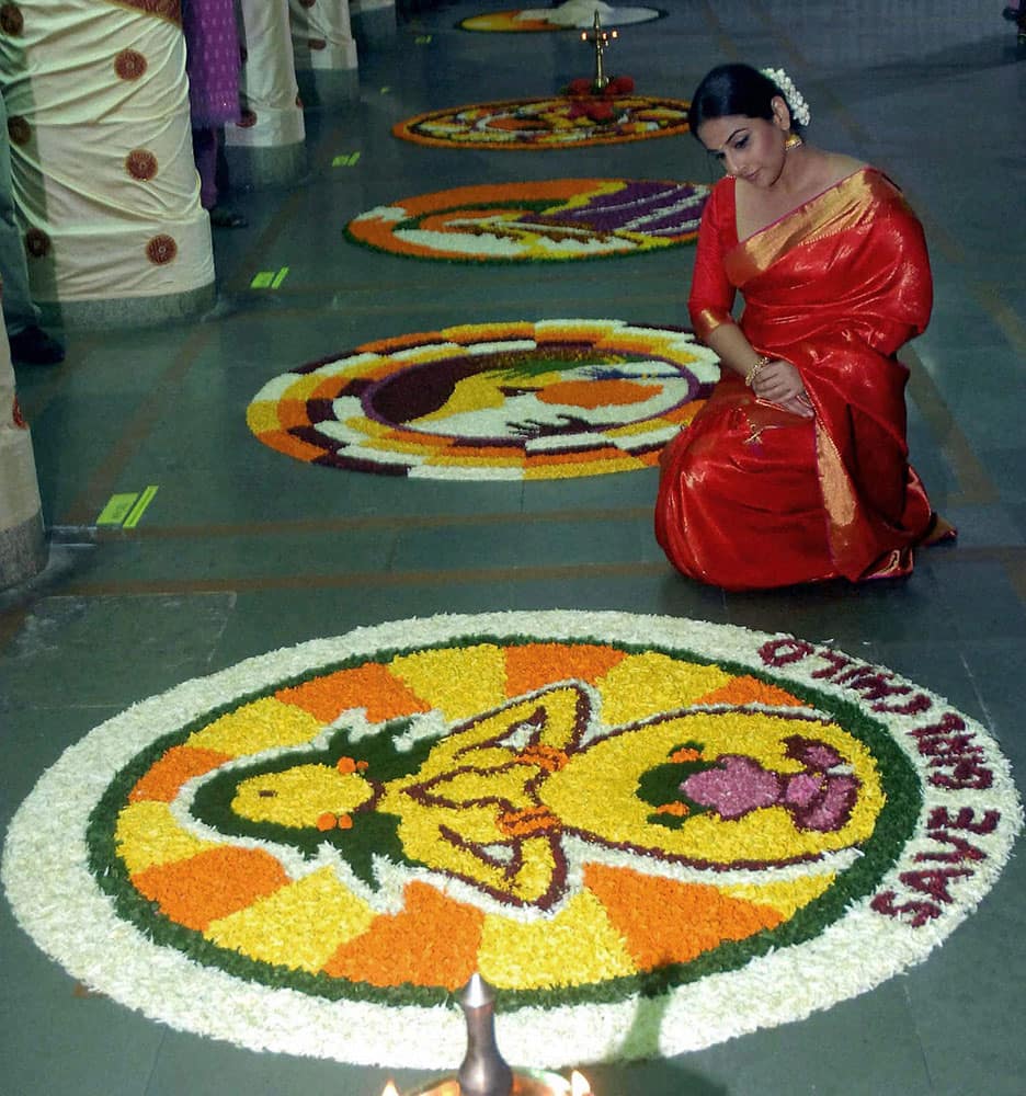 Bollywood actress Vidya Balan admiring the Kerala's flower Rangoli competition in Mumbai.