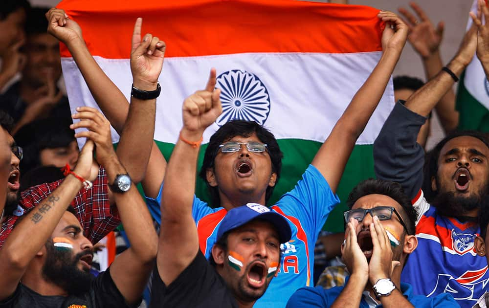 Indian fans cheer for their team during the first match of the two-match friendly soccer tournament between India and Pakistan in Bangalore, India. India won the match 1-0. 