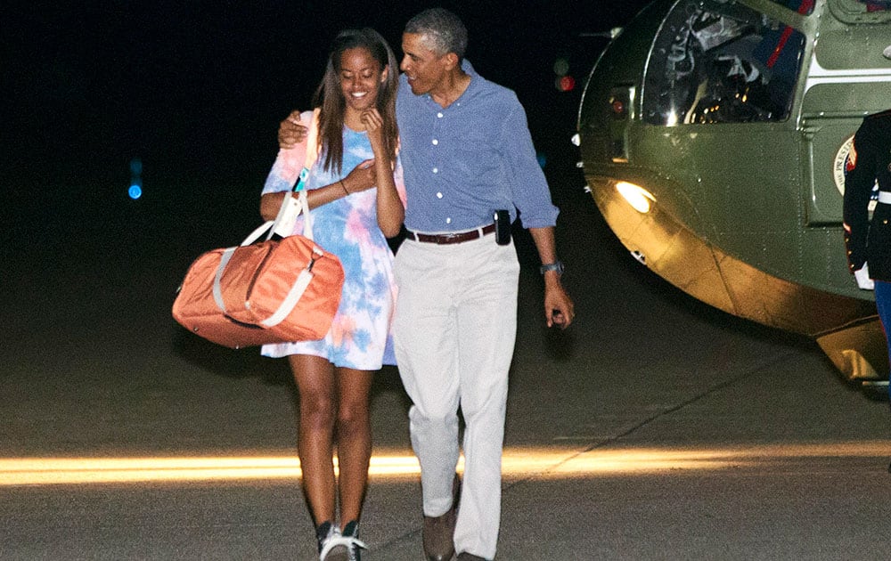 President Barack Obama walks with daughter Malia Obama, to board Air Force One at Cape Cod Coast Guard Air Station in Bourne, Mass., en route to Washington via Cape Cod from the Massachusetts island of Martha`s Vineyard. 