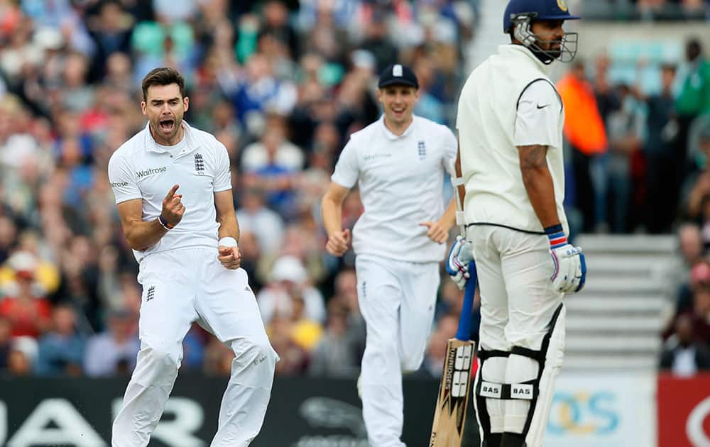 England`s James Anderson, left, celebrates after taking the wicket of India`s Murali Vijay, right, LBW, during the third day of the fifth test cricket match at Oval cricket ground in London.