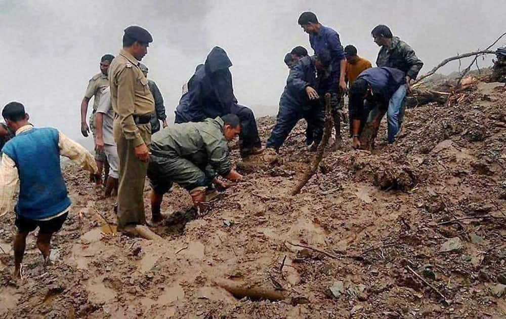 Rescue team busy in rescuing the people and dead bodies at Kathbangla area in Dehradun.