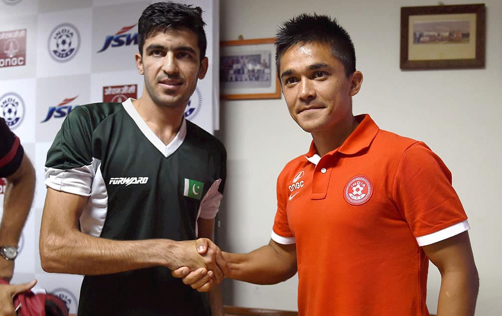 Indian football captain Sunil Chettri (R) greets his counterpart from Pakistan Kaleemulla during a press conference ahead of their U-23 exhibition match in Bengaluru.