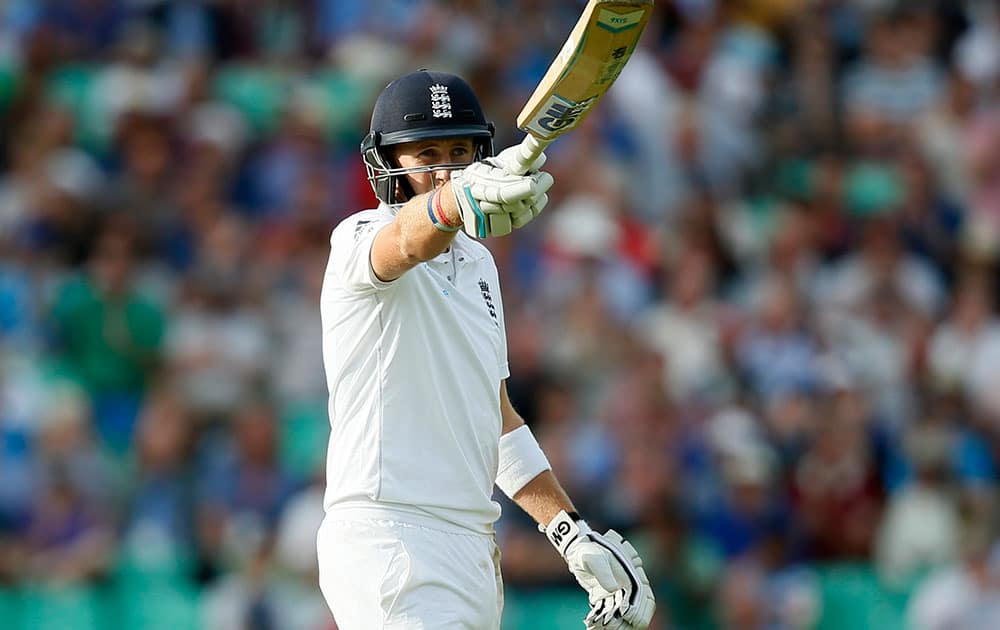 England`s Joe Root celebrates getting 50 runs not out during the second day of the fifth test cricket match against India at Oval cricket ground in London.