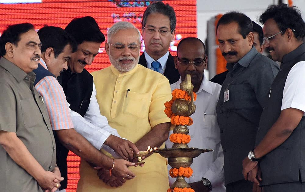 Prime Minister Narendra Modi along with Nitin Gadkari, Minister of Road Transport and Highways and Maharastra Chief Minister Prithviraj Chavan during the foundation stone laying function for a Rs 4,000 crore SEZ project at Jawaharlal Nehru Port Trust (JNPT) near Mumbai.