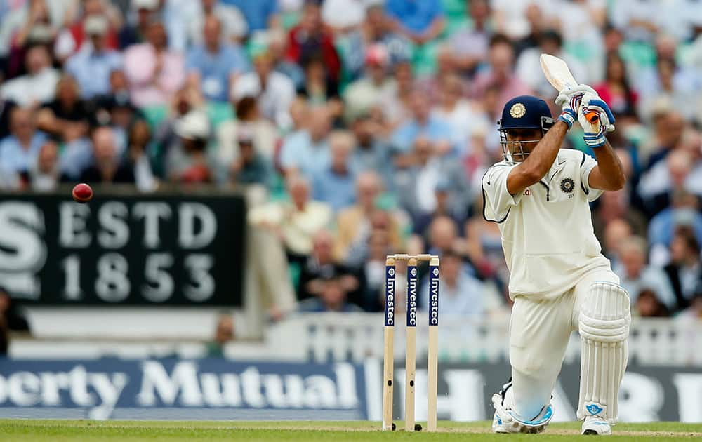 India's MS Dhoni hits two runs off the bowling of England's Stuart Broad during the first day of the fifth test cricket match at Oval cricket ground in London.