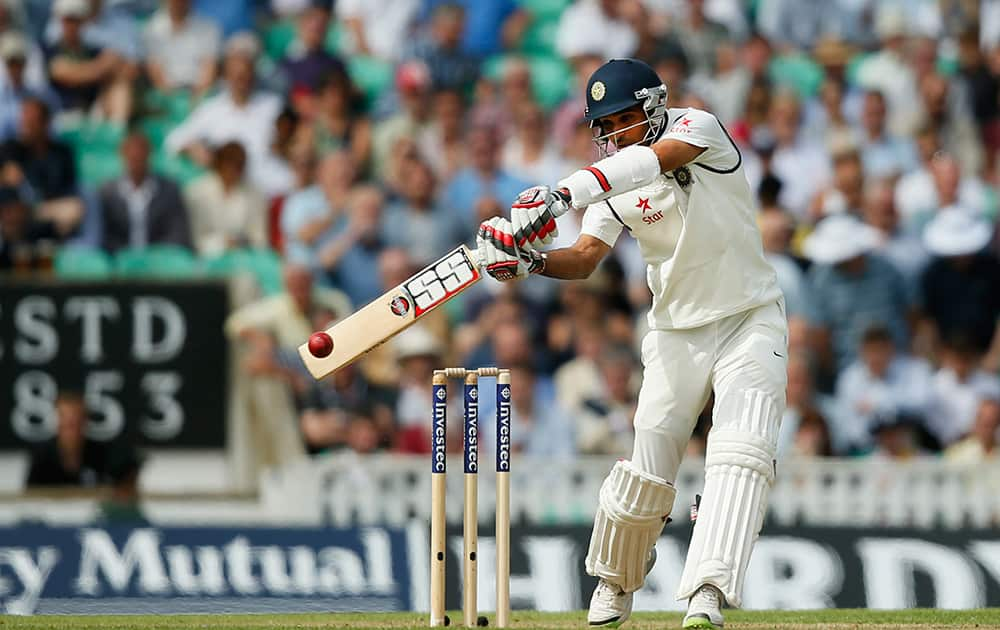 India's Bhuvneshwar Kumar hits a ball off the bowling of England's Chris Jordan during the first day of the fifth test cricket match at Oval cricket ground in London.