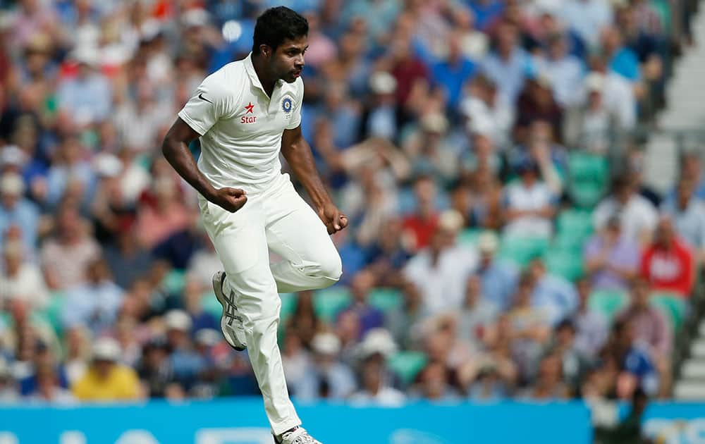 Varun Aaron celebrates after taking the wicket of England's Sam Ronson during the second day of the fifth test cricket match at Oval cricket ground in London.