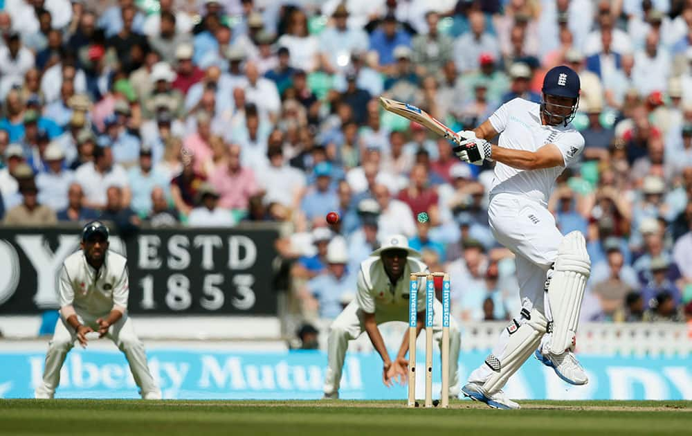 England's Alastair Cook hits a ball off the bowling of India's Ishant Sharma during the second day of the fifth test cricket match at Oval cricket ground in London.