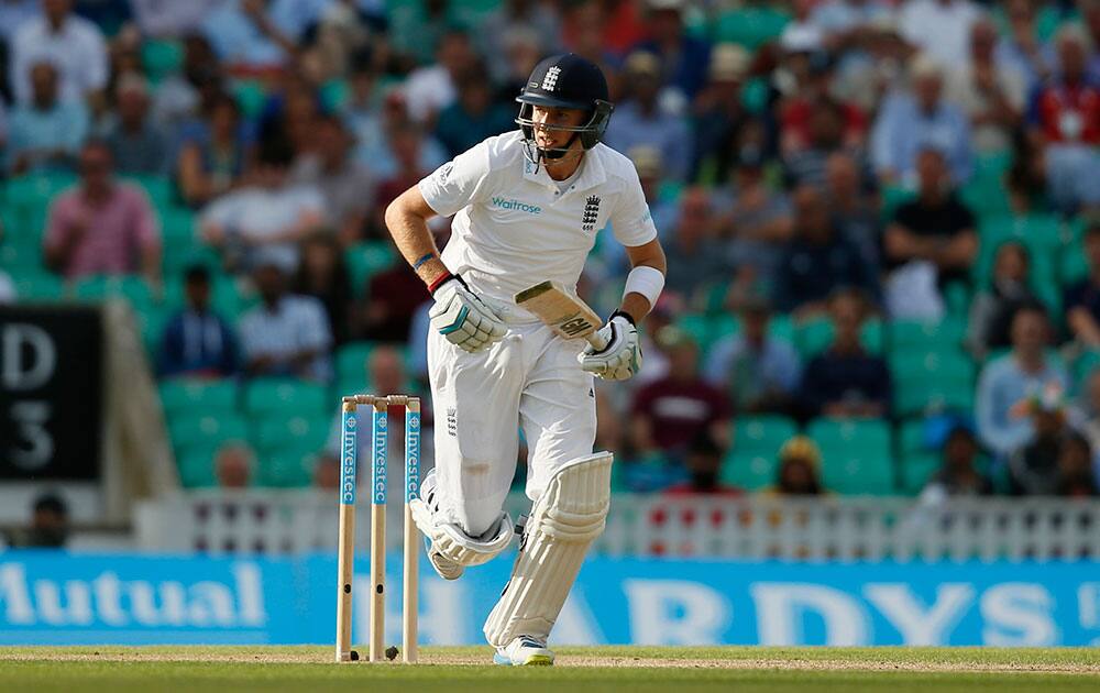 England's Joe Root takes two runs off the bowling of India's Ishant Sharma during the second day of the fifth test cricket match at Oval cricket ground in London.