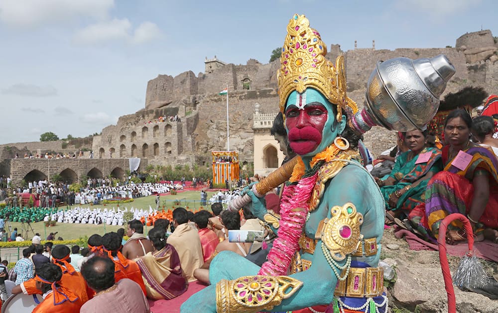 An Indian artist dressed as Hindu monkey-God Hanuman waits to perform during independence Day celebrations at Golconda Fort in Hyderabad.