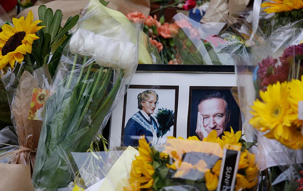 Flowers and photographs are displayed, in San Francisco, of a makeshift memorial for actor Robin Williams outside a home which was used in the filming of the movie `Mrs. Doubtfire.`