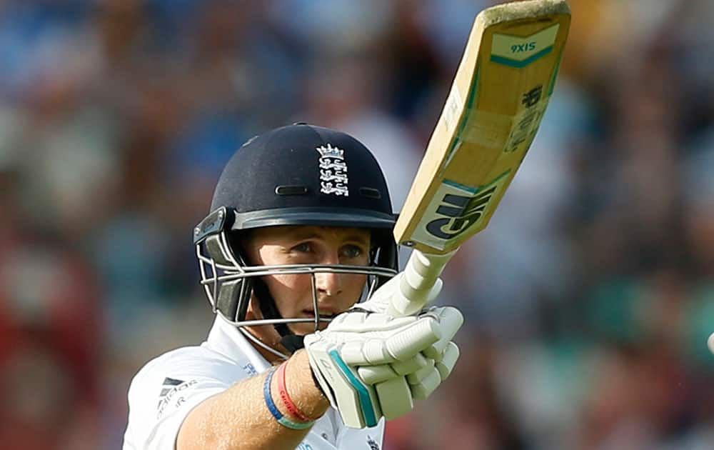 England's Joe Root celebrates getting 50 runs not out during the second day of the fifth test cricket match against India at Oval cricket ground in London.