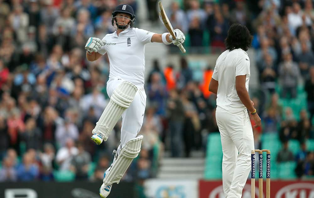 England's Joe Root celebrates scoring 100 runs not out during the third day of the fifth test cricket match against India at Oval cricket ground in London.