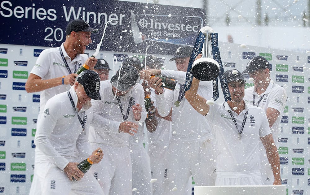 The England cricket team celebrate with champagne their 3-1 series win, after defeating India on the third day of the fifth test cricket match at Oval cricket ground in London.