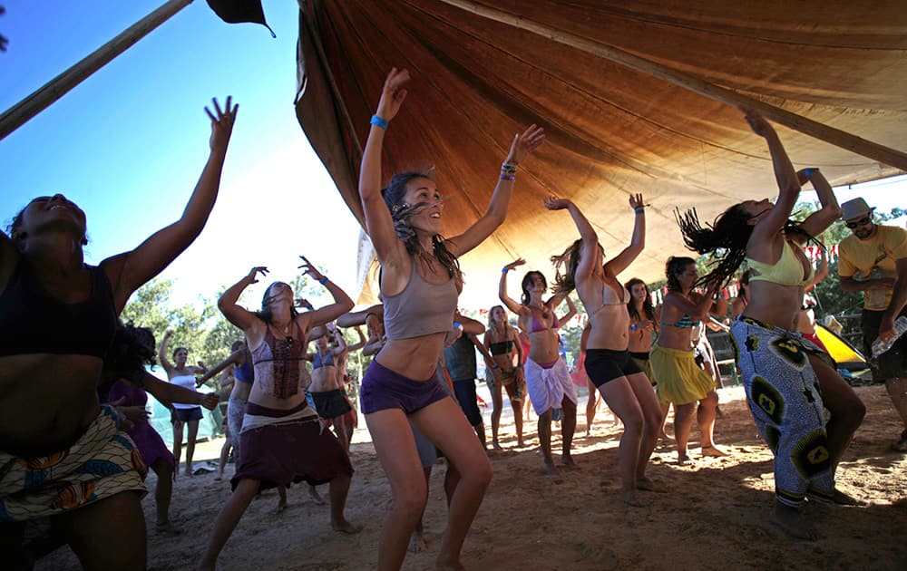 Women dance during a didgeridoo music festival in Sitio das Fontes, near Estombar, southern Portugal.