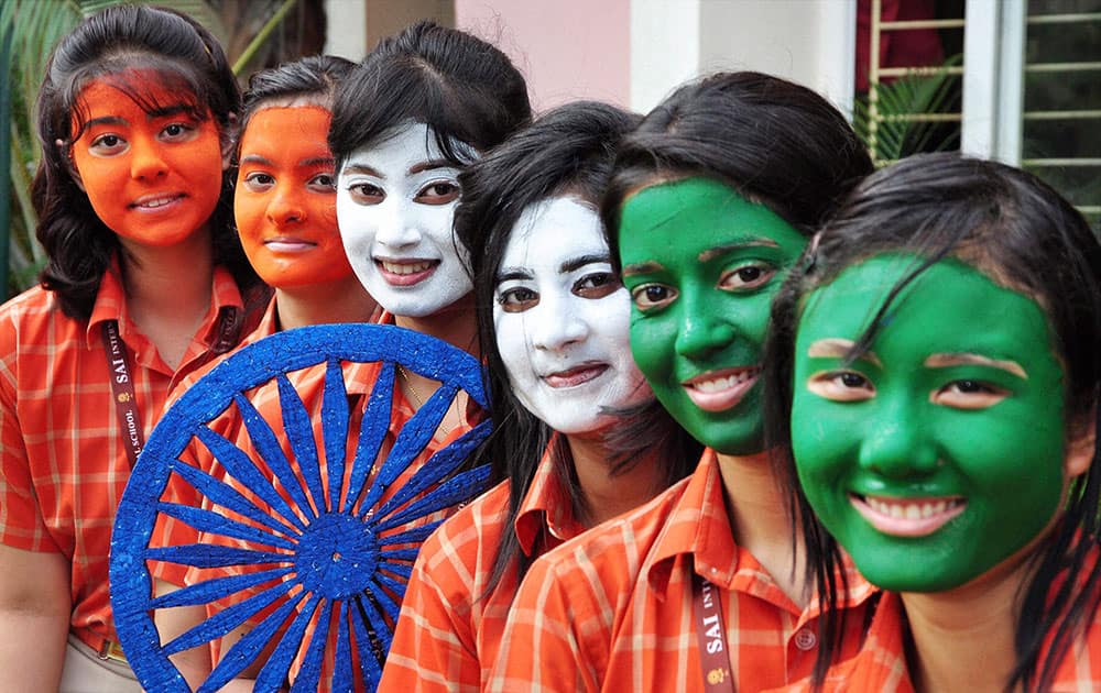 School students paint their faces with tri-colours on the eve of Independence Day in Bhubaneswar.