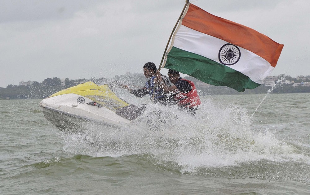 Youth enjoying in a motor boat ride with the national flag on the eve of Independence Day at Upper Lake in Bhopal.