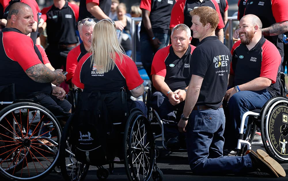 Britain`s Prince Harry speaks to the competitors during the announcement of the British Armed Forces team for the Invictus Games in London.