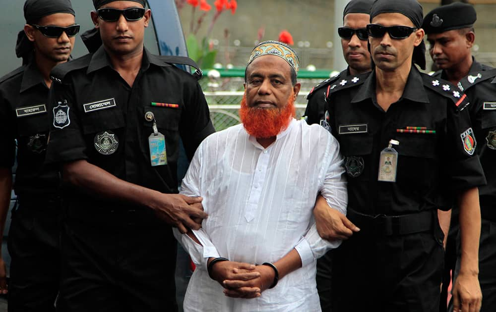 Bangladesh’s anti-crime Rapid Action Battalion personnel escort Abu Bakar Siddique, as they bring him to Dhaka, Bangladesh. Siddique, the owner of a Bangladesh ferry that sank earlier this month with more than 100 people dead or missing was arrested Wednesday after weeks in hiding, officials said.