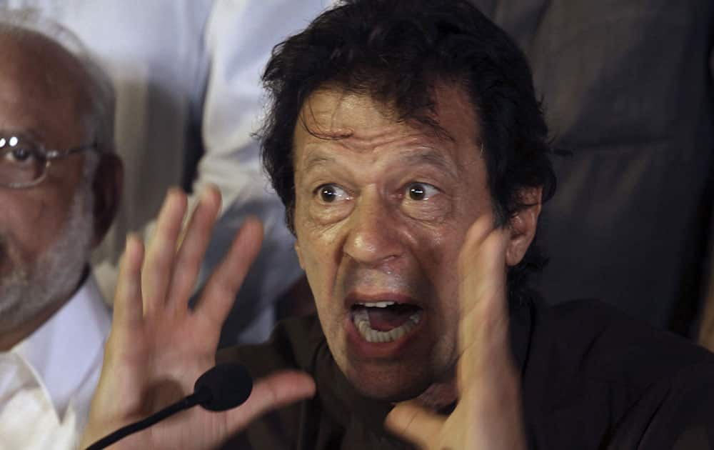 Pakistan`s cricketer-turned-politician Imran Khan, gestures during a press conference, in Lahore, Pakistan. Ahead of planned massive anti-government protests, Pakistan`s capital feels like a city preparing for a siege.