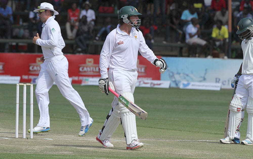 Zimbabwean captain Brendan Taylor walks off the pitch after been dismissed during the cricket Test match against South Africa at the Harare Sports club, in Harare Zimbabwe.