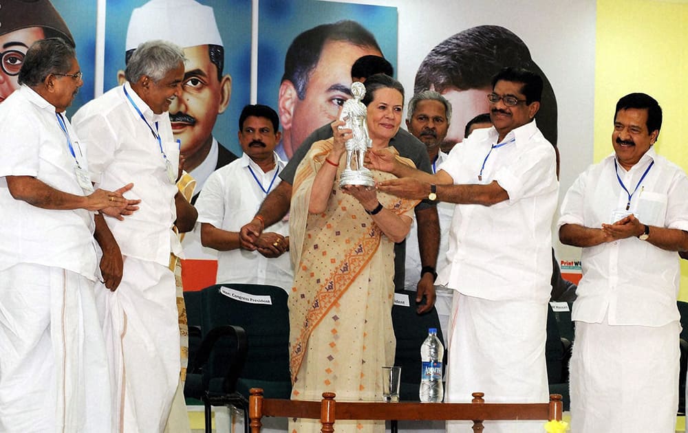 Congress President Sonia Gandhi receiving a memento from Kerala Congress President V M Sudheeran after addressing a special convention of the party`s state unit at the party office in Thiruvananthapuram.