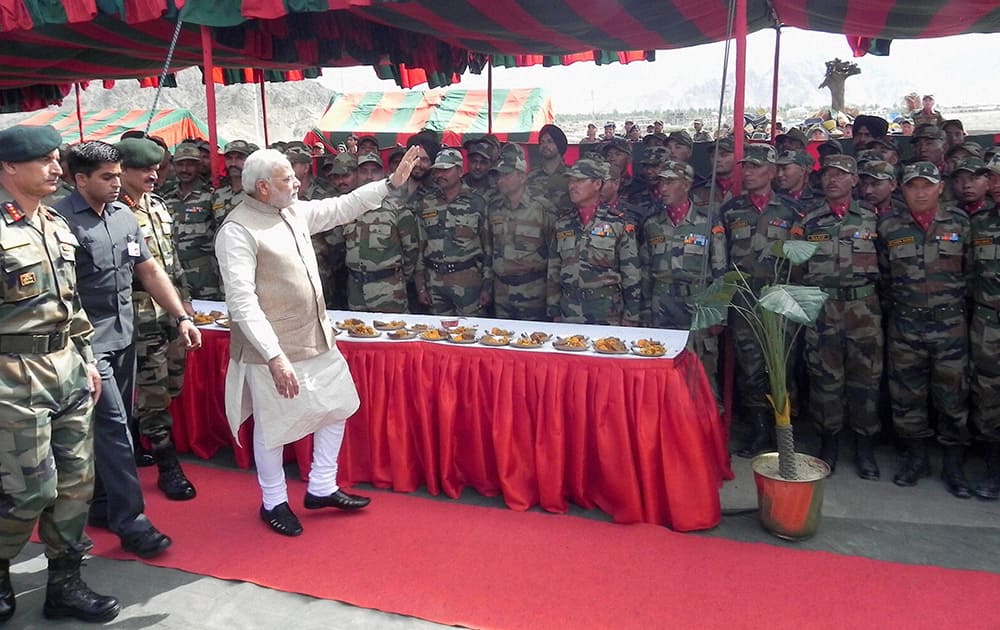 Prime Minister Narendra Modi waves at army soldiers in Leh.