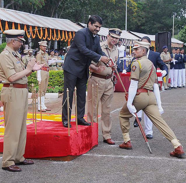 Maharashtra`s Minister of State for Satej Patil presents Sword of Honour to best trainee of the batch Sandeep Rangrao Singh during a passing out parade at Maharashtra Police Academy (MPA) in Nashik.