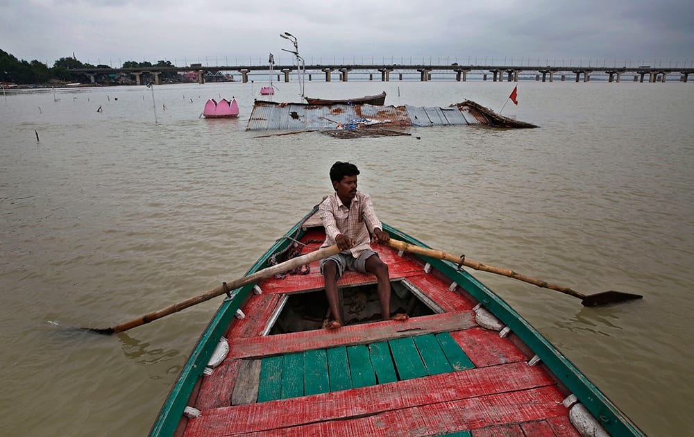 A boatman rows his boat in the River Ganges, flooded after heavy monsoon rains in Allahabad.