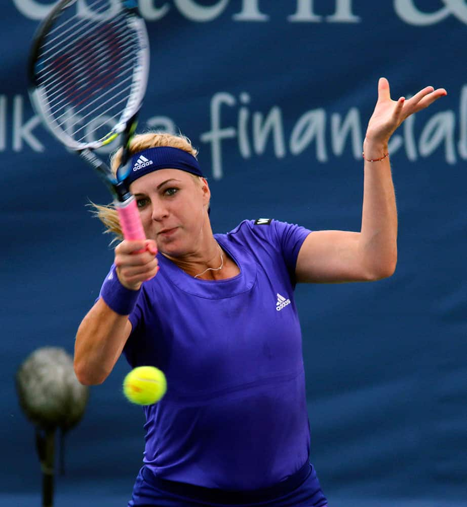 Anastasia Pavlyuchenkova, of Russia, returns a volley to Dominika Cibulkova, of Slovakia, at the Western & Southern Open tennis tournament.