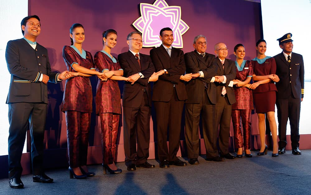 TATA SIA Airlines limited, crew members pose with their top officials from fourth left, Directors on Board Swee Wah Mak, Mukund Rajan, Chairman Prasad Menon and CEO Teik Yeoh, at a press conference to unveil the name and logo of the new airline’ Vistara’ in New Delhi.