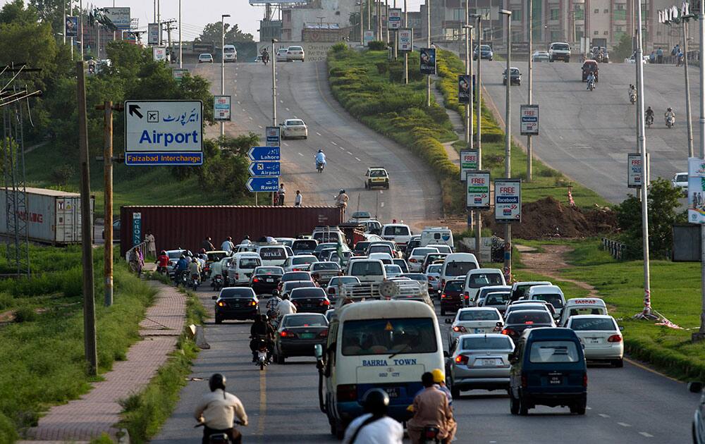 Pakistani authorities place containers on the road leading to Islamabad to stop activists of Pakistan Tehreek-i-Insaf, chaired by Pakistan`s cricketer-turned politician Imran Khan and supporters of Canadian Muslim cleric Tahirul Qadri.