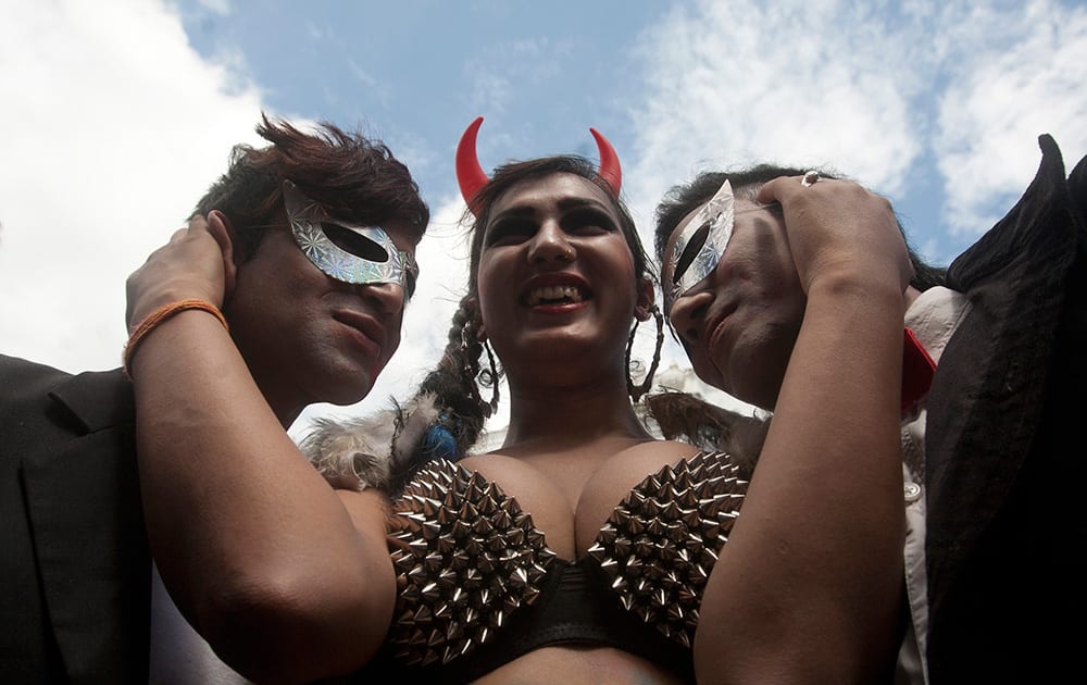 Participants pose for the cameras as hundreds of lesbians, gays, bisexuals and transvestites parade through the streets during Gaijatra festival in Katmandu, Nepal.